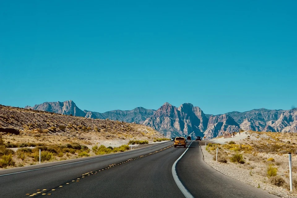 a photo of the road, dessert and mountains