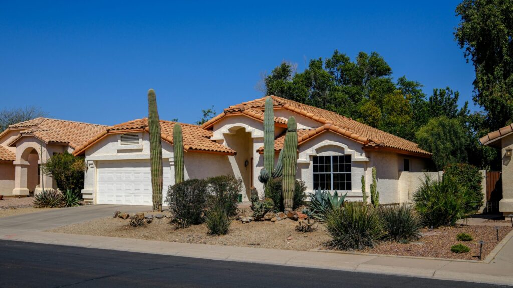 a house in the desert with cacti.